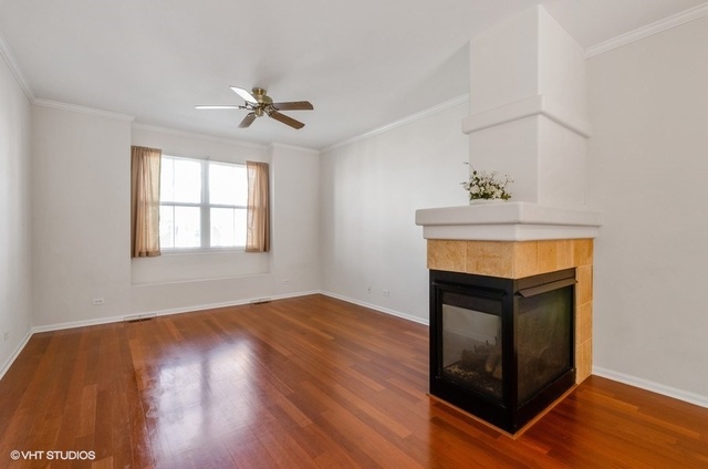 6128 Washington Court Morton Grove, IL 60053 - Photo 2 of 11 a view of empty room with window and fireplace