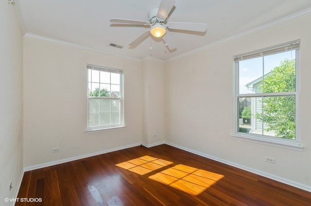 6128 Washington Court Morton Grove, IL 60053 - Photo 7 of 11 a view of empty room with wooden floor and fan