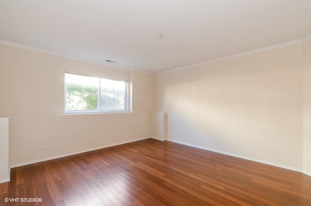 6128 Washington Court Morton Grove, IL 60053 - Photo 10 of 11 an empty room with wooden floor and windows
