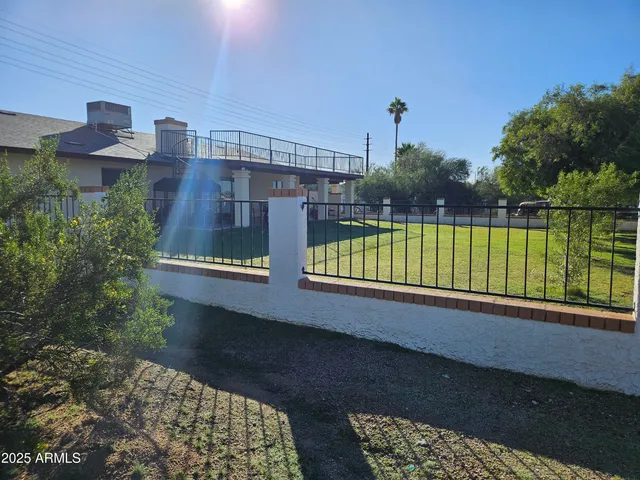 a view of a house with a yard from a balcony