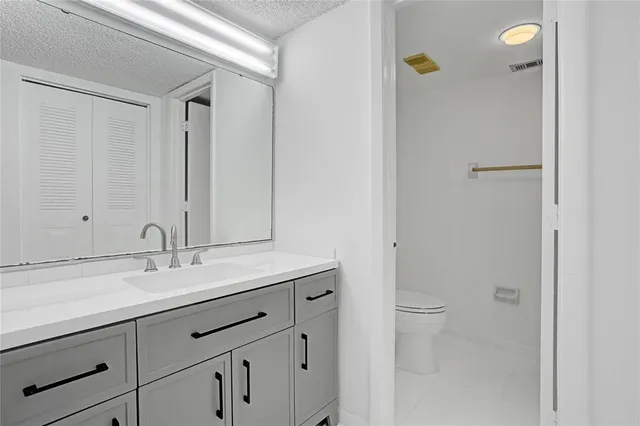 an empty room with wooden floor and closet