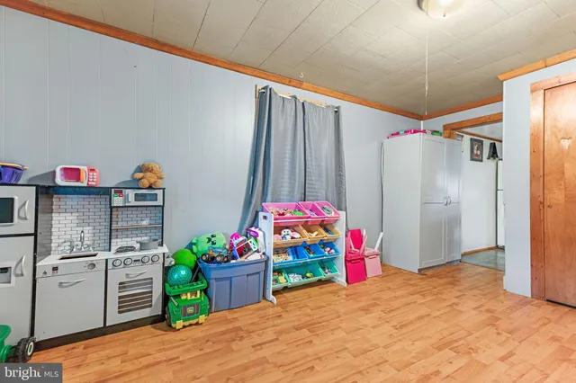 a kitchen view with granite countertop stainless steel appliances a refrigerator and a sink