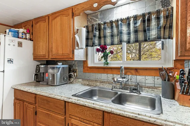 a kitchen with a sink and a refrigerator