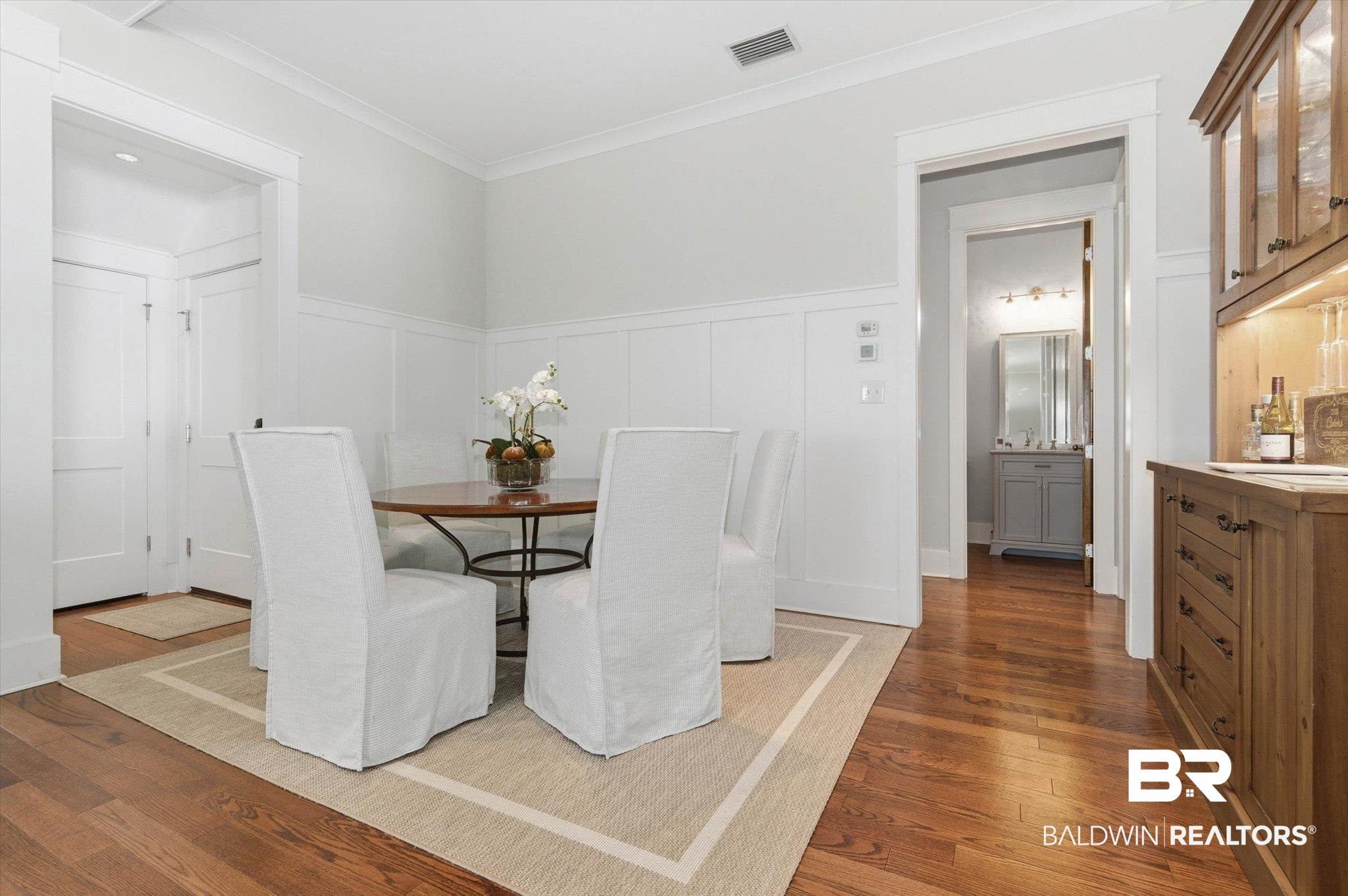 3704 Stein Street Mobile, AL 36608 - Photo 8 of 37 Dining area featuring a decorative wall, dark wood-type flooring, crown molding, and wainscoting