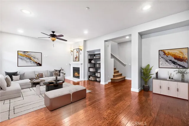a living room with furniture and wooden floor