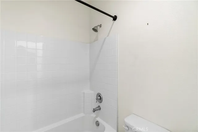 a bathroom with a bathtub and a toilet