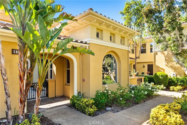 a front view of a building with a garden