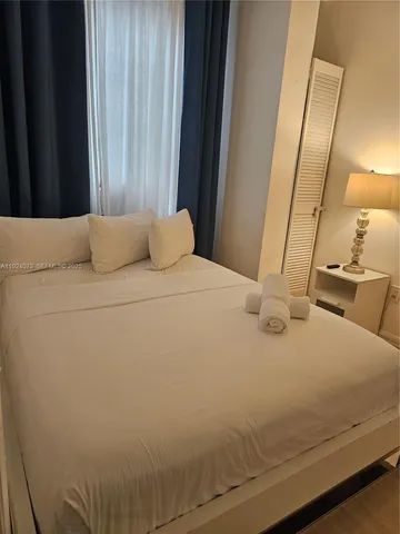 a bedroom with a bed and a mirror