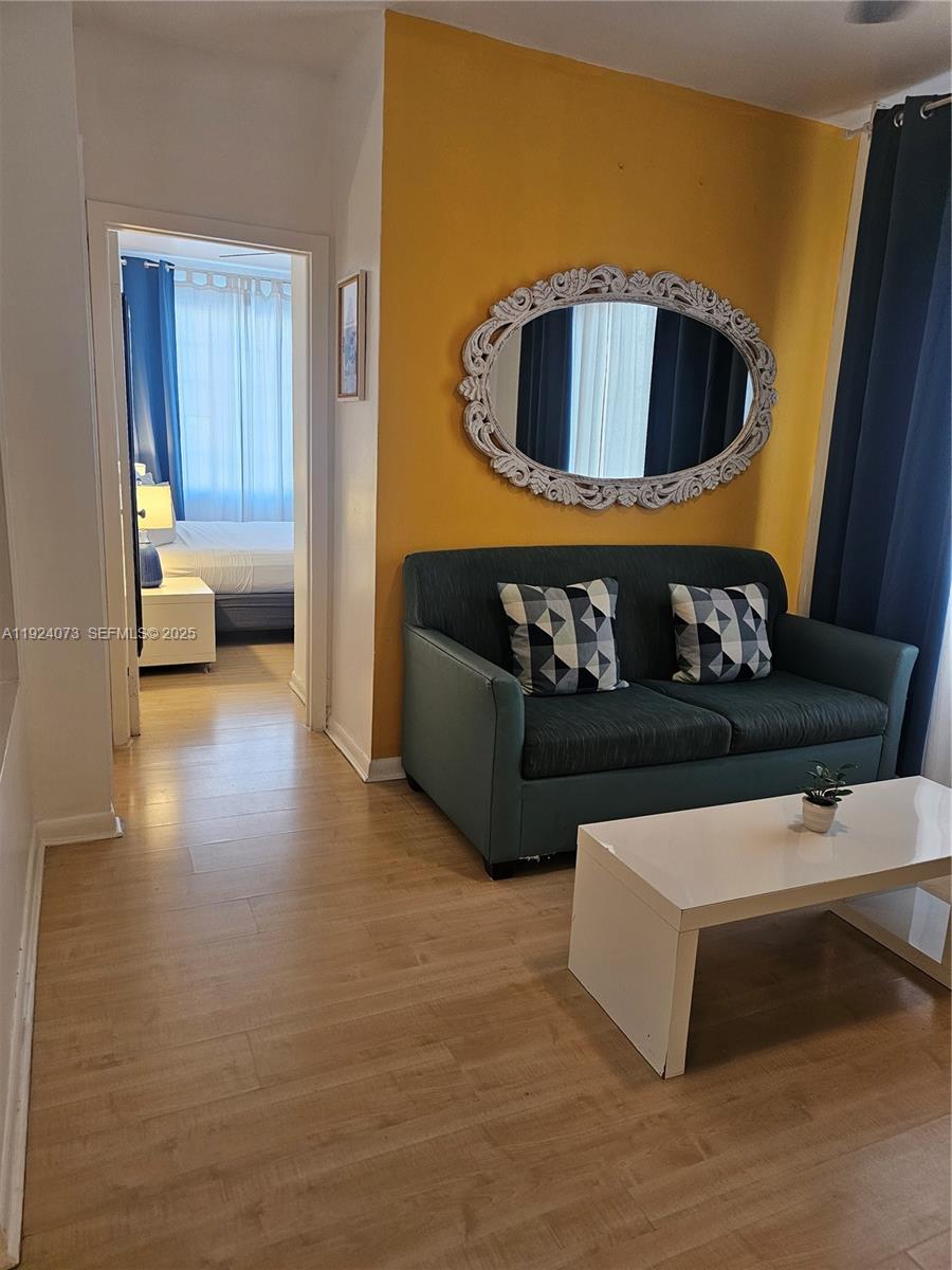 750 Collins Avenue, Unit 201 Miami Beach, FL 33139 - Photo 14 of 39 a living room with furniture and a couch