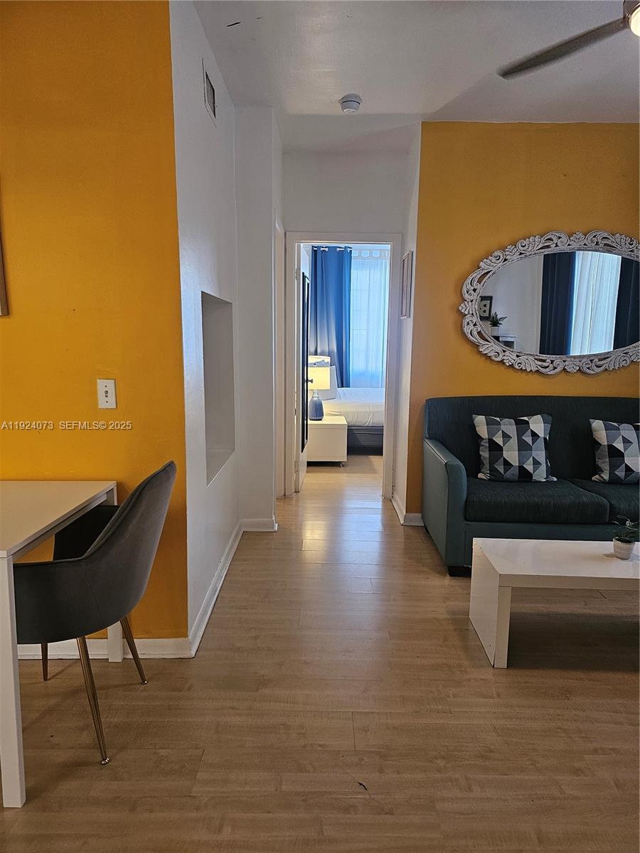 750 Collins Avenue, Unit 201 Miami Beach, FL 33139 - Photo 15 of 39 a living room with furniture and a wooden floor