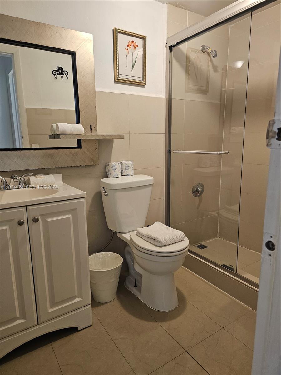 750 Collins Avenue, Unit 201 Miami Beach, FL 33139 - Photo 21 of 39 a bathroom with a toilet sink and shower