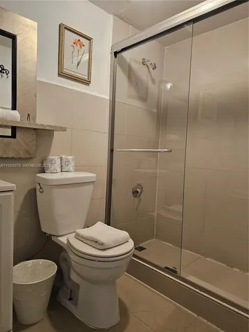 a white toilet sitting next to a bathroom sink