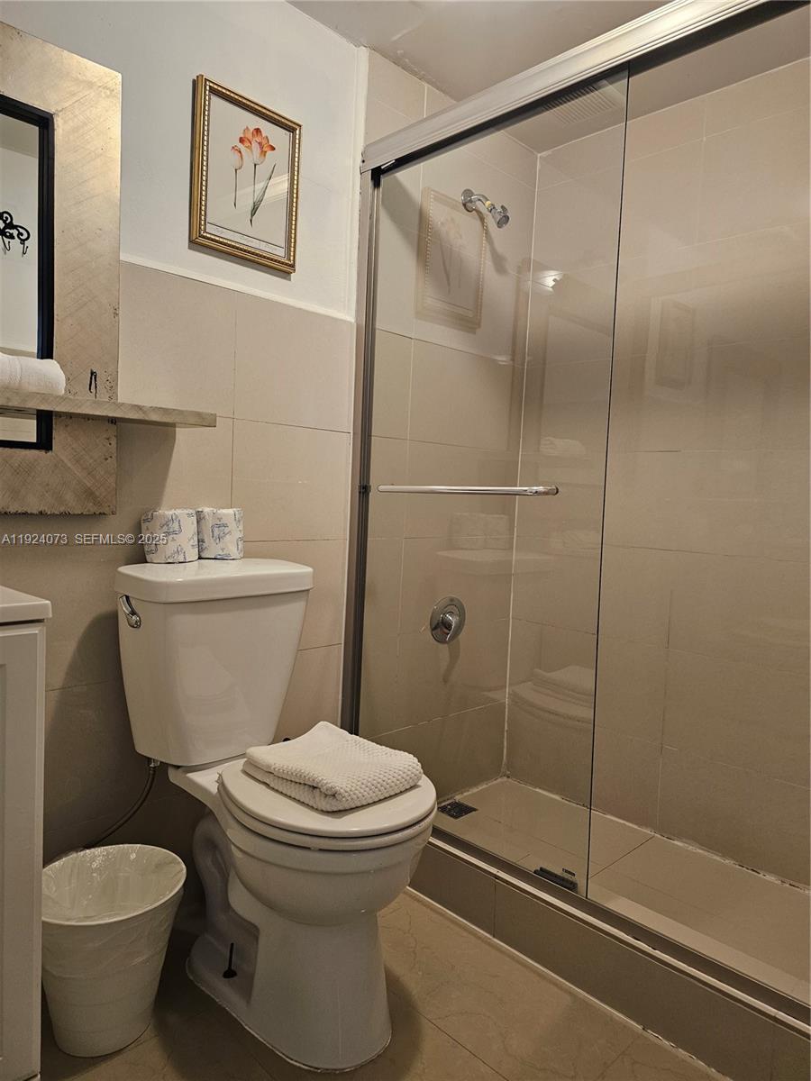750 Collins Avenue, Unit 201 Miami Beach, FL 33139 - Photo 23 of 39 a white toilet sitting next to a bathroom sink