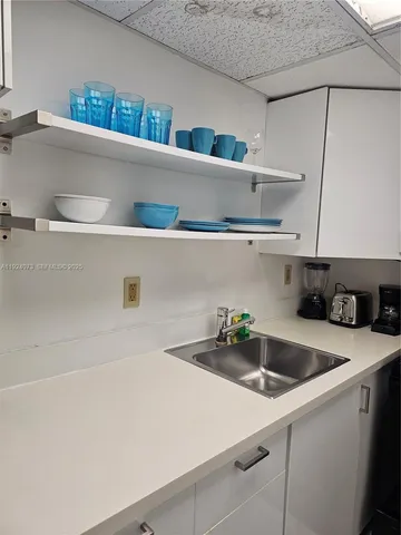 a kitchen with a white cabinets and white appliances