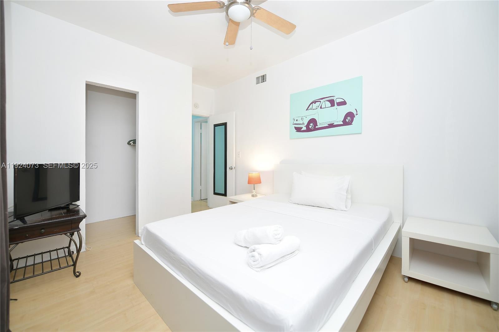 750 Collins Avenue, Unit 201 Miami Beach, FL 33139 - Photo 33 of 39 a bedroom with a bed and a flat screen tv