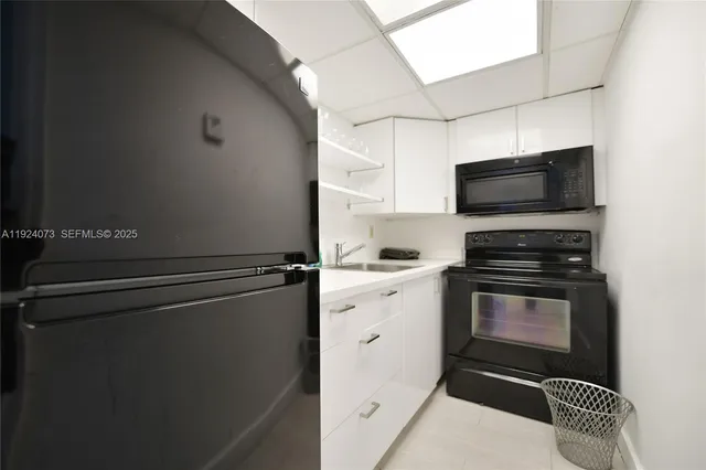 a kitchen with a refrigerator stove and microwave