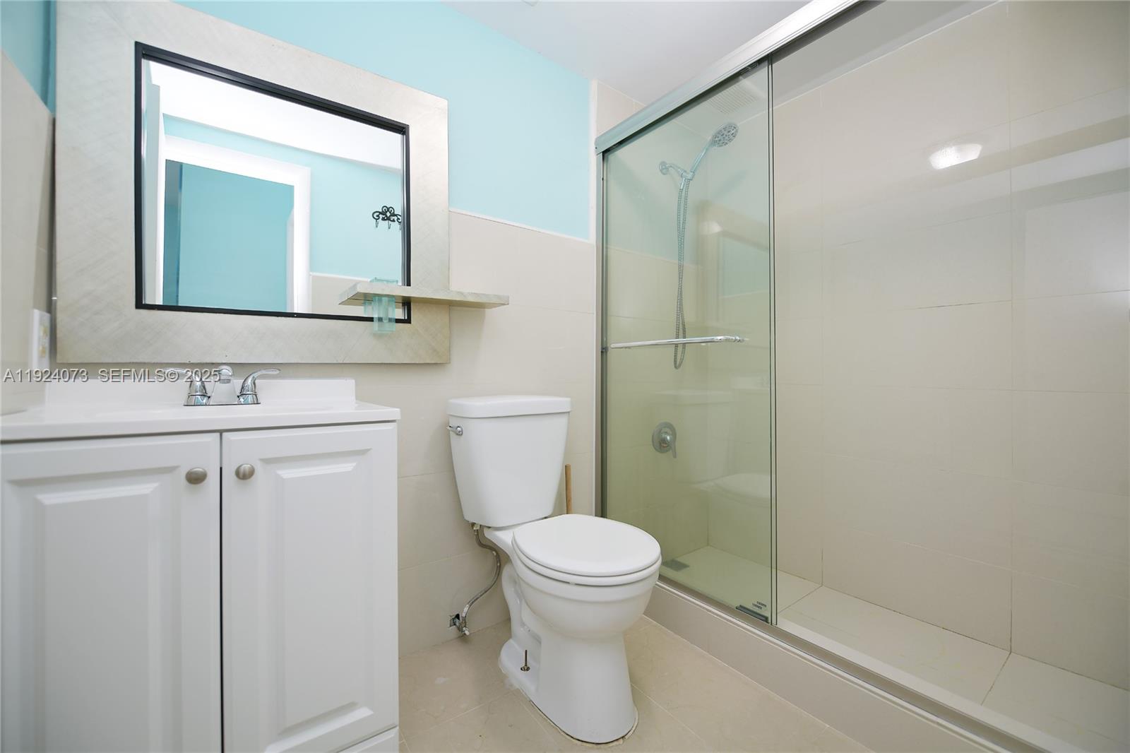 750 Collins Avenue, Unit 201 Miami Beach, FL 33139 - Photo 39 of 39 a bathroom with a toilet a sink and mirror