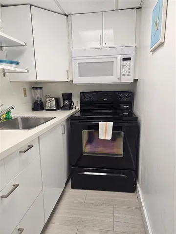 a stove top oven sitting inside of a kitchen