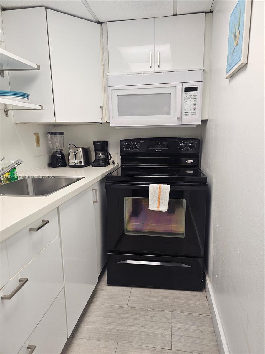 750 Collins Avenue, Unit 201 Miami Beach, FL 33139 - Photo 4 of 39 a stove top oven sitting inside of a kitchen