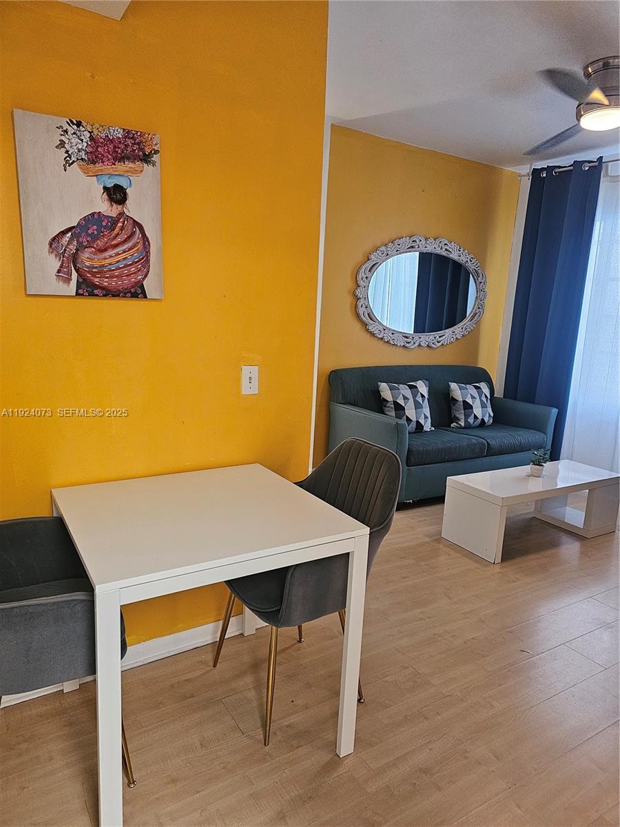 750 Collins Avenue, Unit 201 Miami Beach, FL 33139 - Photo 7 of 39 a view of a livingroom with furniture and wooden floor