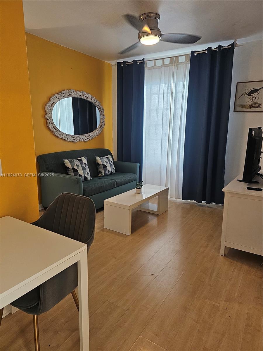 750 Collins Avenue, Unit 201 Miami Beach, FL 33139 - Photo 8 of 39 a living room with furniture and a flat screen tv