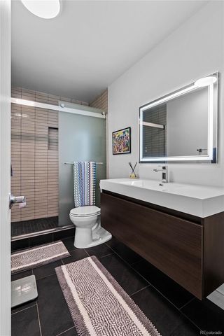 a bathroom with a double vanity sink toilet and shower