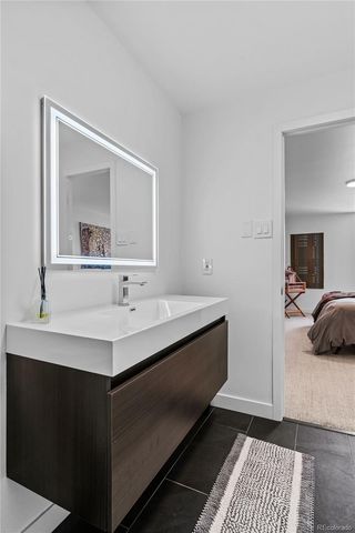 a en suite bathroom with a sink and a mirror