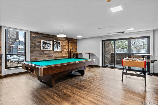 a room with pool table and windows