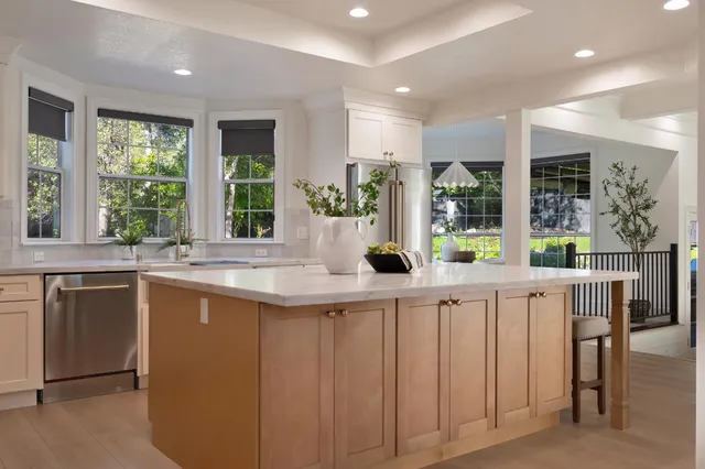 a kitchen with lots of counter space and windows