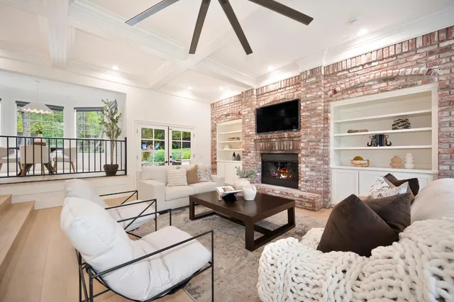 a living room with furniture fireplace and a flat screen tv
