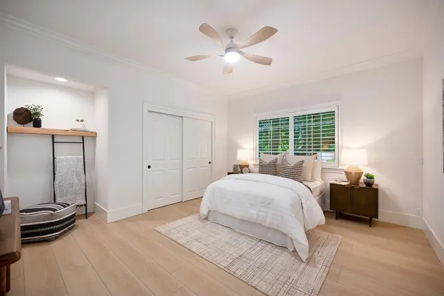 a front view of a house with swimming pool table and chairs