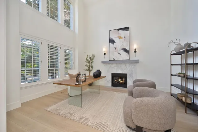 a kitchen with stainless steel appliances granite countertop a stove top oven a sink dishwasher and a refrigerator with wooden floor