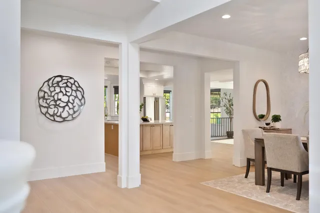 a dining room with furniture and a potted plant