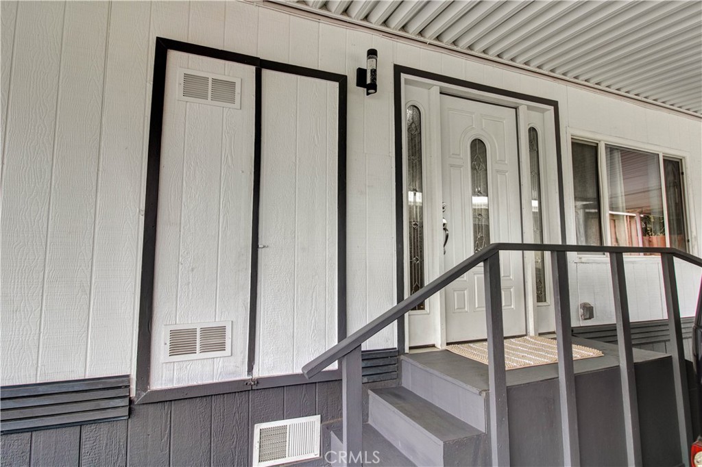 1025 South Riverside Avenue, Unit 26 Rialto, CA 92376 - Photo 5 of 27 a view of a hallway with wooden floor and staircase