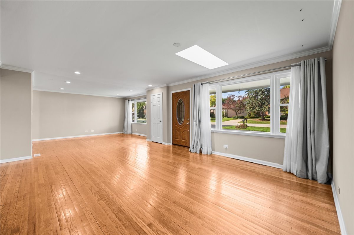 203 Coldren Drive Prospect Heights, IL 60070 - Photo 13 of 31 a view of an empty room with wooden floor and a window