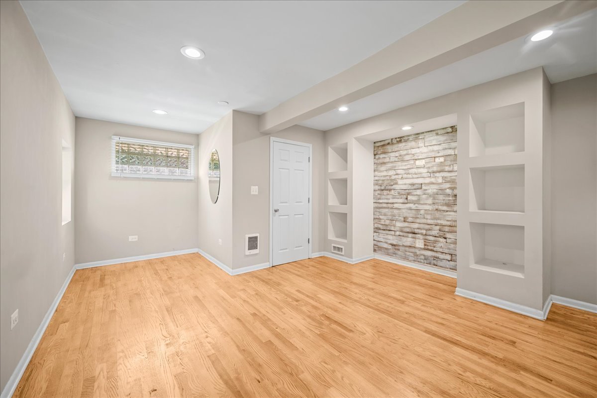 203 Coldren Drive Prospect Heights, IL 60070 - Photo 21 of 31 a view of an empty room with wooden floor and a window