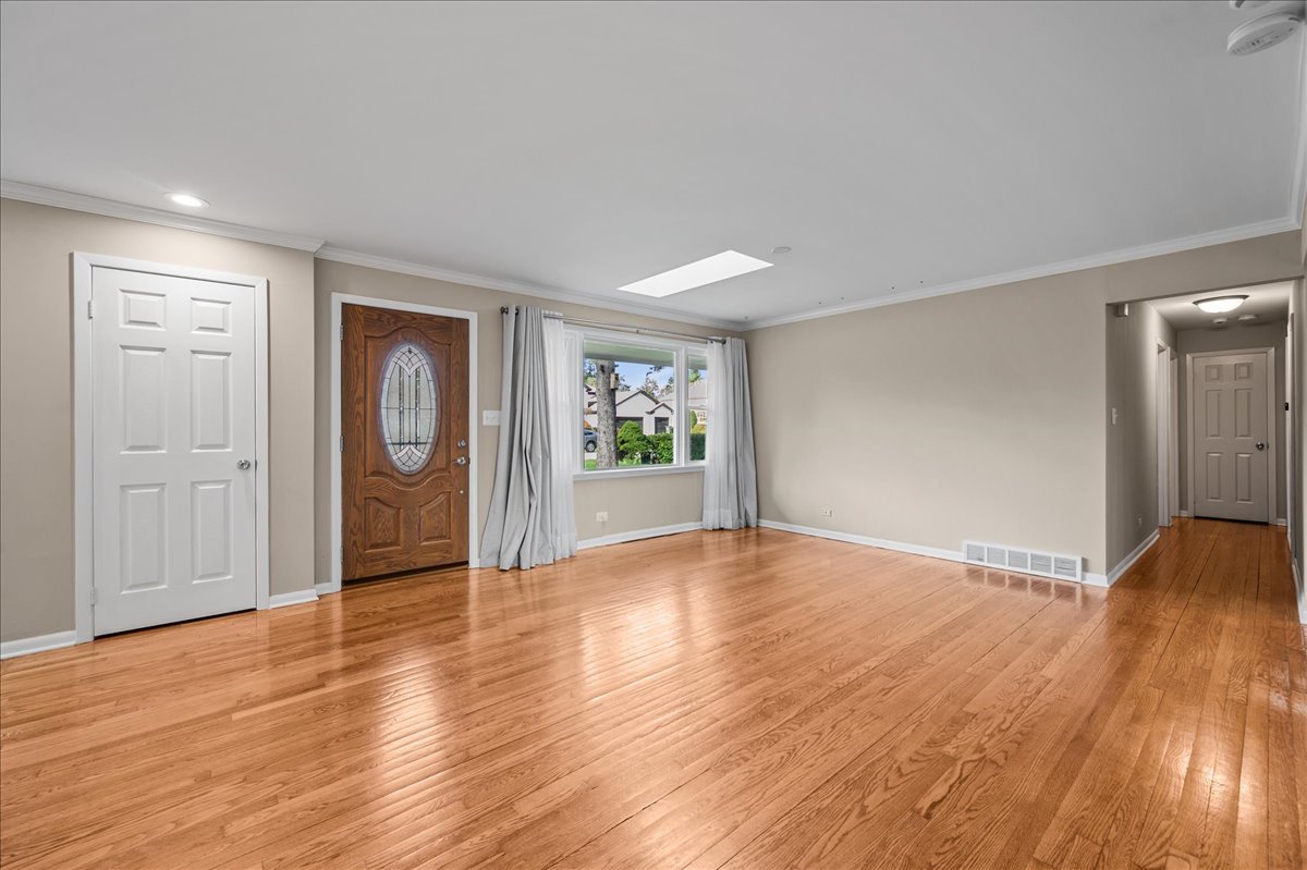 203 Coldren Drive Prospect Heights, IL 60070 - Photo 3 of 31 an empty room with wooden floor and windows