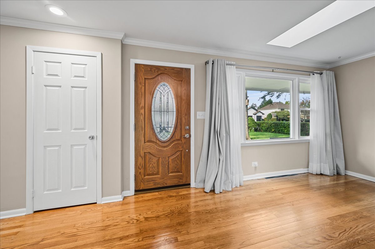 203 Coldren Drive Prospect Heights, IL 60070 - Photo 4 of 31 an empty room with window wooden floor and glass door