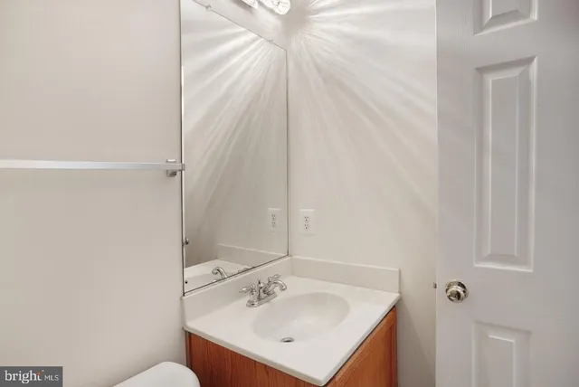 a bathroom with a sink mirror and vanity