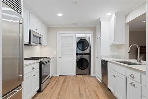 a kitchen with sink cabinets and wooden floor