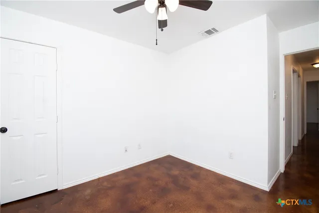 a view of a room with a ceiling fan