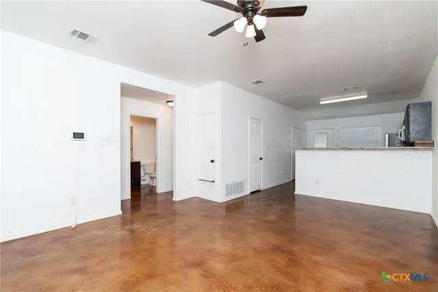 a view of a kitchen with a sink and a refrigerator