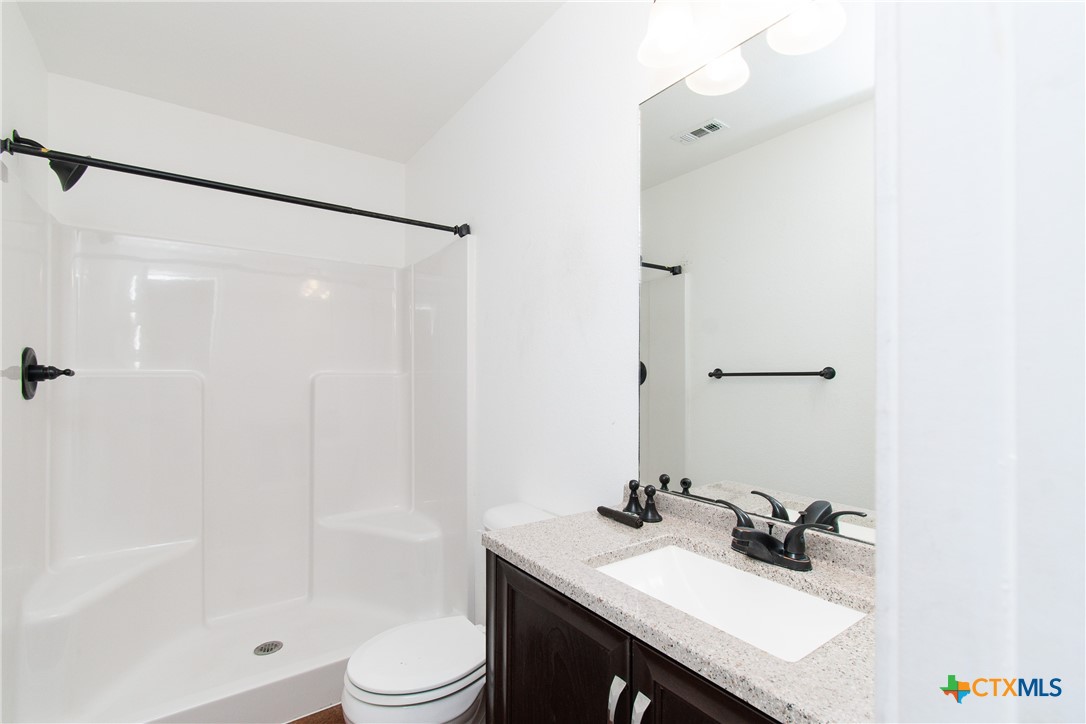 235 North Mary Jo Drive, Unit A Harker Heights, TX 76548 - Photo 10 of 16 a bathroom with a sink a toilet and shower