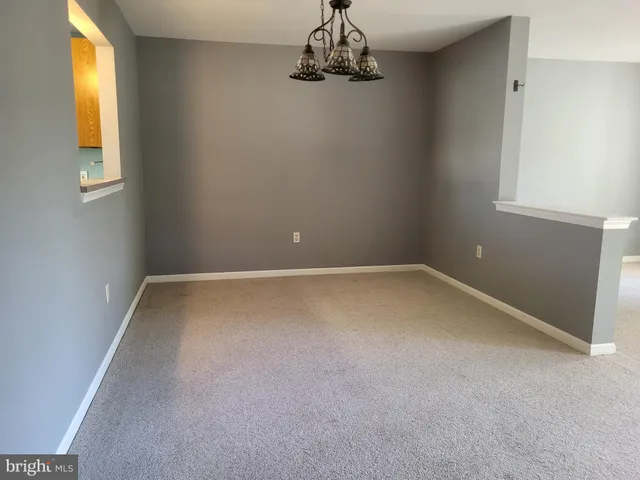 a kitchen with a stove top oven cabinets and a refrigerator