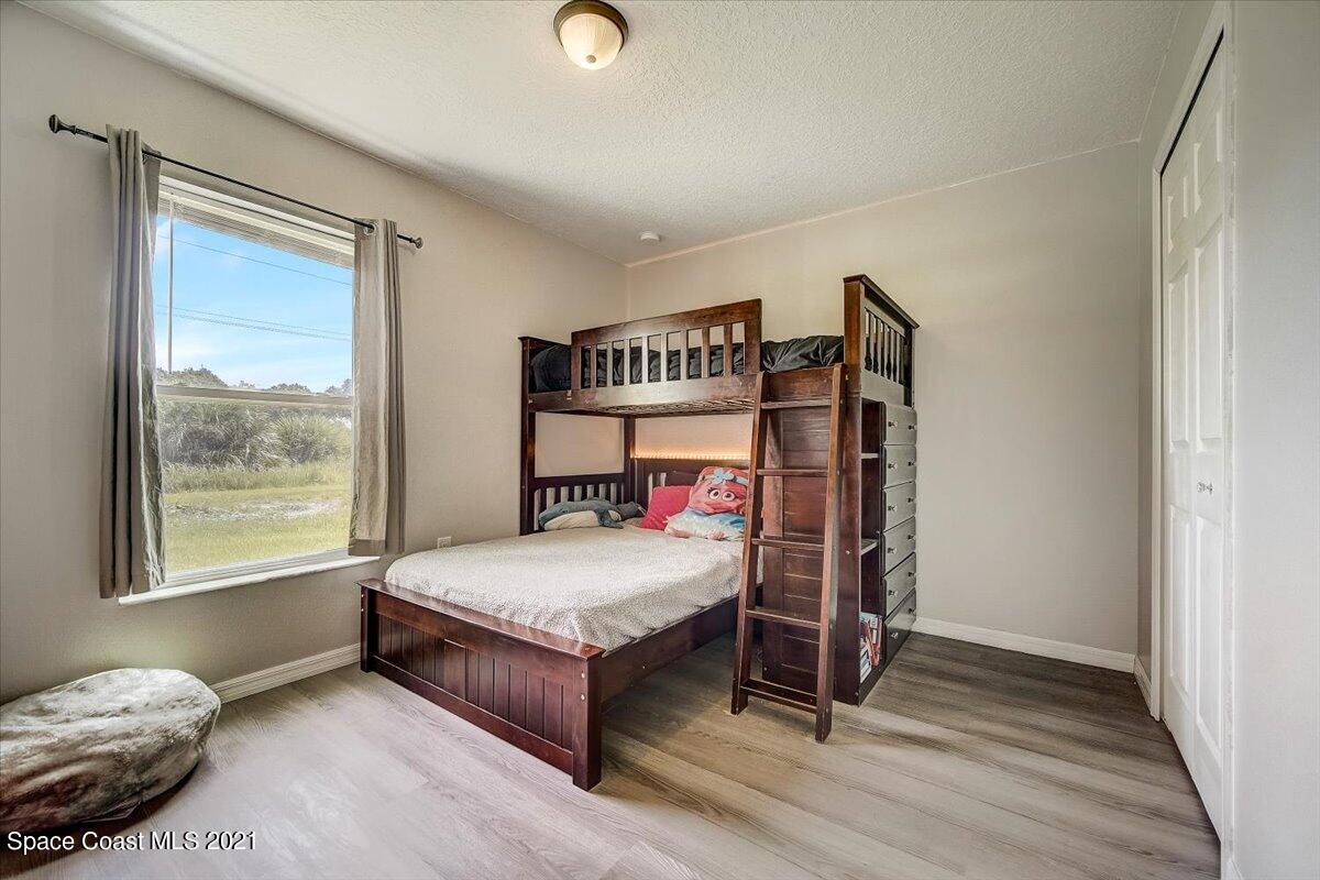1459 Saxony Road Southwest Palm Bay, FL 32908 - Photo 14 of 38 a bedroom with a bed and a window