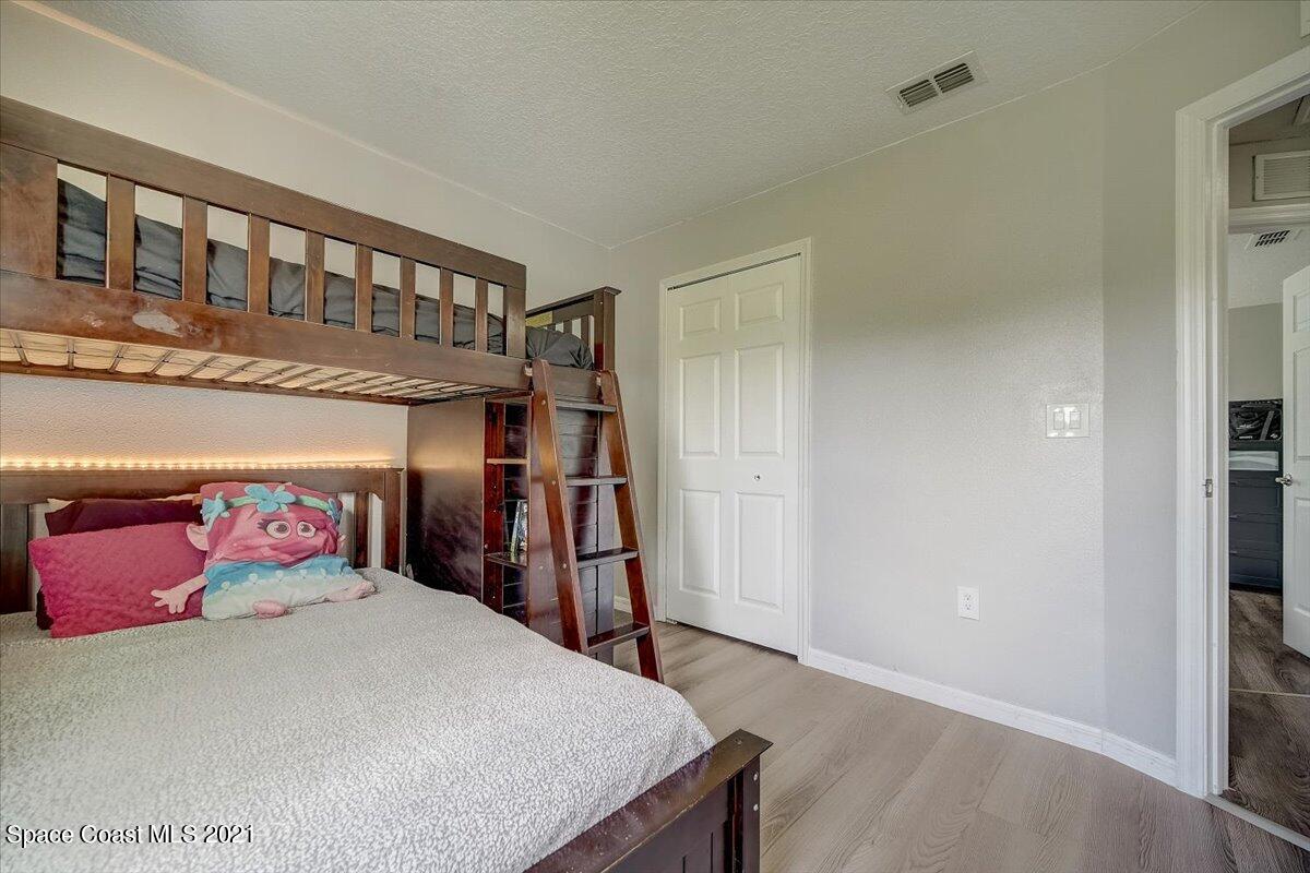 1459 Saxony Road Southwest Palm Bay, FL 32908 - Photo 15 of 38 a bedroom with a bed and a closet