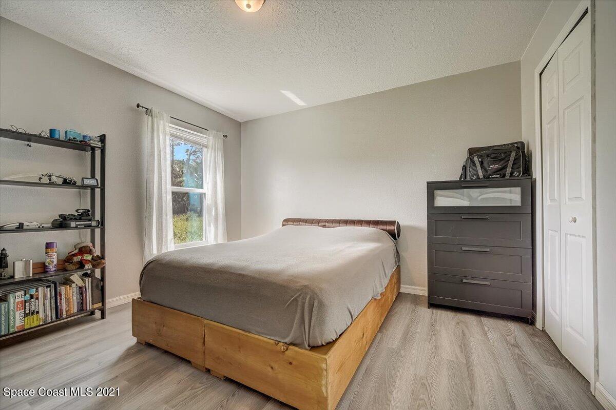 1459 Saxony Road Southwest Palm Bay, FL 32908 - Photo 16 of 38 a bedroom with a bed and a window