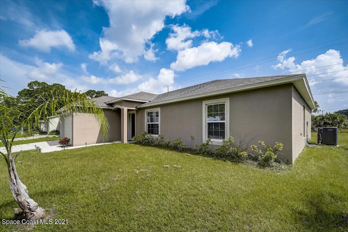 1459 Saxony Road Southwest Palm Bay, FL 32908 - Photo 3 of 38 a view of a house with a garden