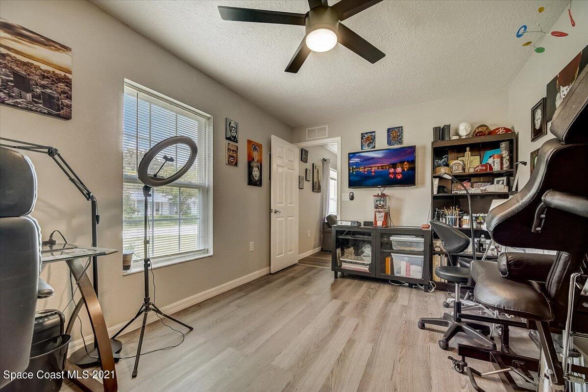 1459 Saxony Road Southwest Palm Bay, FL 32908 - Photo 22 of 38 a view of a workspace with furniture and a window
