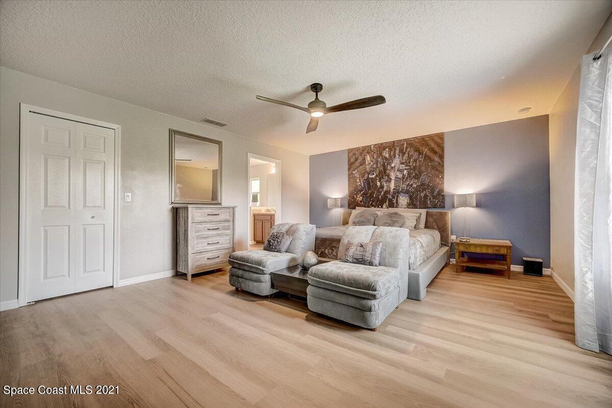 1459 Saxony Road Southwest Palm Bay, FL 32908 - Photo 23 of 38 a living room with furniture and a ceiling fan